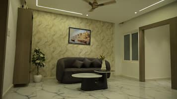 Deluxe Double Room | Living area | 5-inch LCD TV with cable channels
