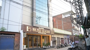 Un hotel con un letrero que dice 'BLISS KASHI' y 'RESTAURANTE', indicando que hay servicio de comidas en el establecimiento.