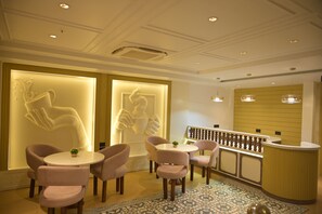 A reception area with a counter, seating, and decorative wall art.