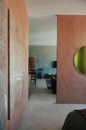 A modern interior with a minimalist design, featuring a desk, chair, and a large vase with plants. - Stylish Boavista King Bed Studio - Casa da Musica (Porto)