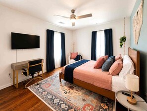 A bedroom with a bed, desk, chair, TV, and a ceiling fan. - Atlanta Oasis with a Spa Suite, Huge Backyard, Fire Pit & Hammocks (Atlanta)