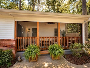 A house with a covered porch, wooden railing, and potted plants. - Atlanta Oasis with a Spa Suite, Huge Backyard, Fire Pit & Hammocks (Atlanta)