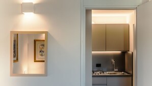 A modern kitchen with stainless steel appliances, a built-in oven, and a sink. - CS Spanish Steps Boutique A Apartment (Rome)