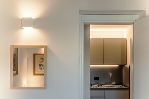 A modern kitchen with stainless steel appliances, a built-in oven, and a sink. - CS Spanish Steps Boutique A Apartment (Rome)