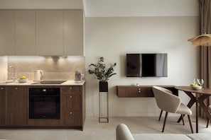 A modern kitchen with a built-in oven, a coffee maker, and a sink. - Olivia Pulse Gdańsk (Gdańsk)