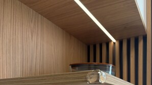 A wooden shelf with a glass container, a white towel, and toiletries on a wooden counter. - The Royal Suite under the castle with river views & private parking (Bratislava-Staré Mesto)