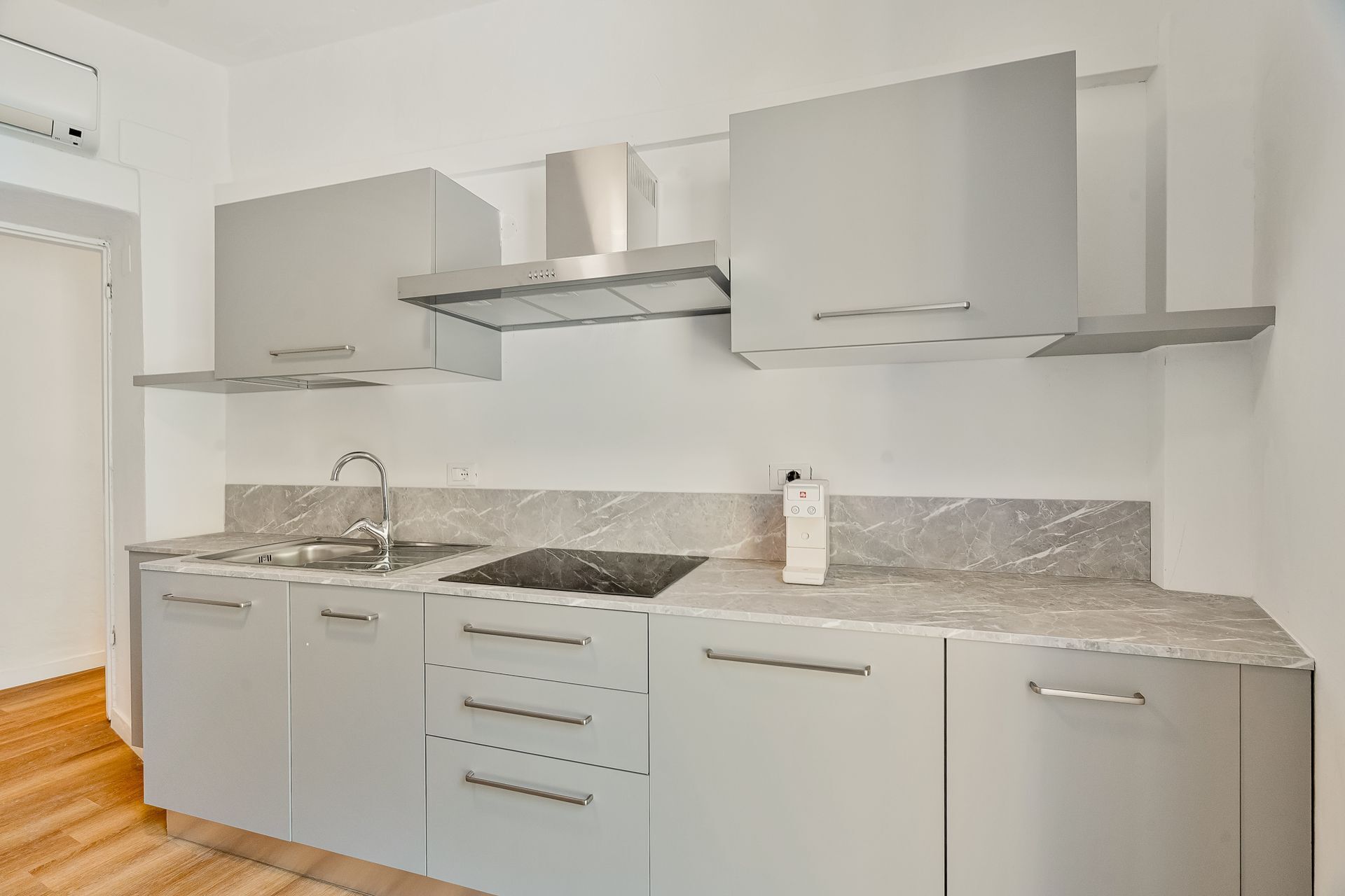 A modern kitchen with a built-in sink, a stove, and a microwave.