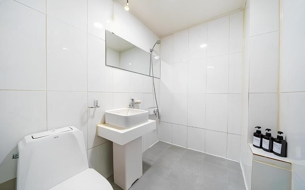 Ein modernes Badezimmer mit Toilette, Waschbecken und Dusche.