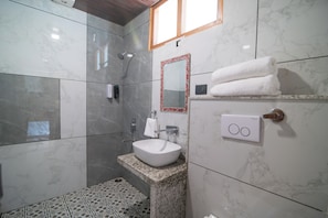 A bathroom with a marble floor, a white sink, a mirror with a red frame, and a towel rack. - Giri River Retreat (Theog)