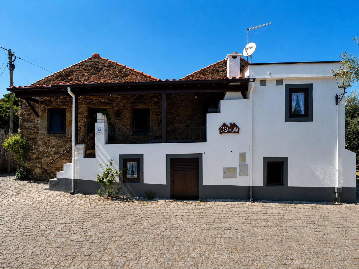 A two-story building with a stone facade, a tiled roof, and a sign reading 'CASA de LAIA'.