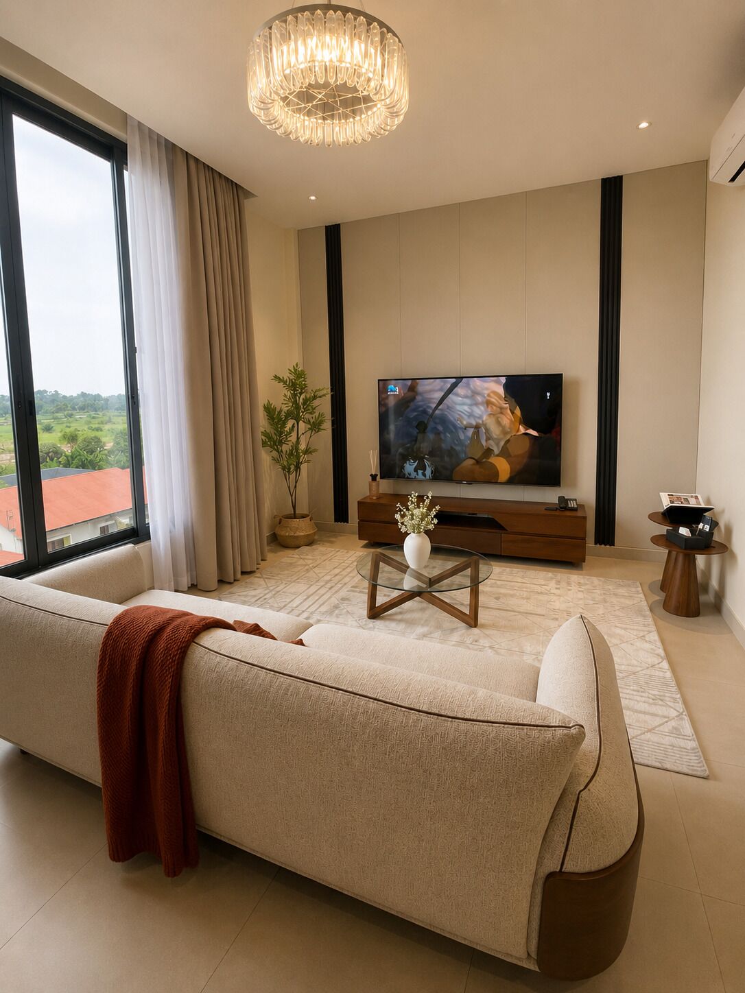 A modern living room with a large TV, sofa, and a decorative glass coffee table.