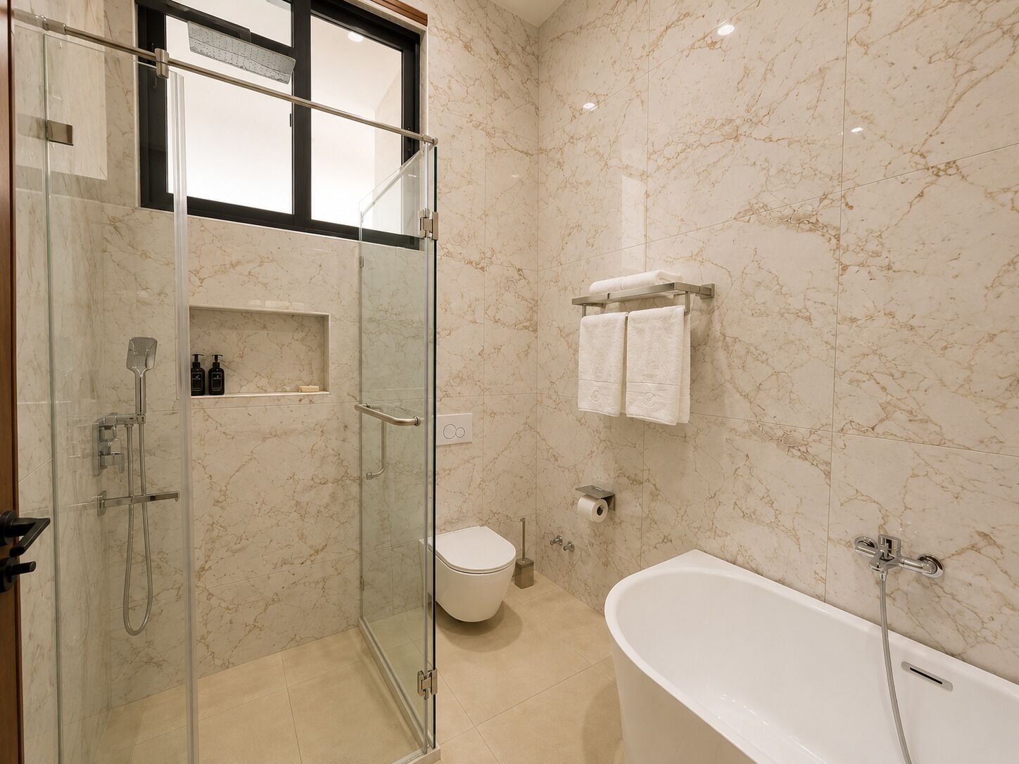 A modern bathroom with a glass-enclosed shower, a white toilet, and a freestanding bathtub.