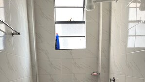 A bathroom with a toilet, a bidet, a shower area, and a window with a view. - Luxury 1BR Near Two Rivers & Karura Fast Wi-Fi Free Parking Lift Backup Power (Kiambu County)