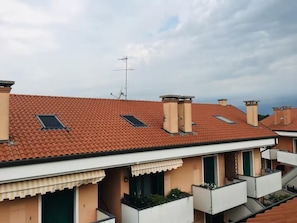 A residential building with a red-tiled roof, multiple chimneys, and satellite dishes. - Your Best Home in Venice: A Cozy Apartment Just 5 Minutes from the Airport (Venezia)