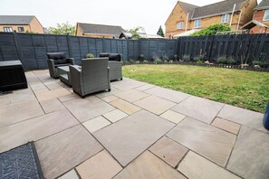 A patio with outdoor furniture and a fenced backyard. - Relaxing Riverside Retreat (Gainsborough)