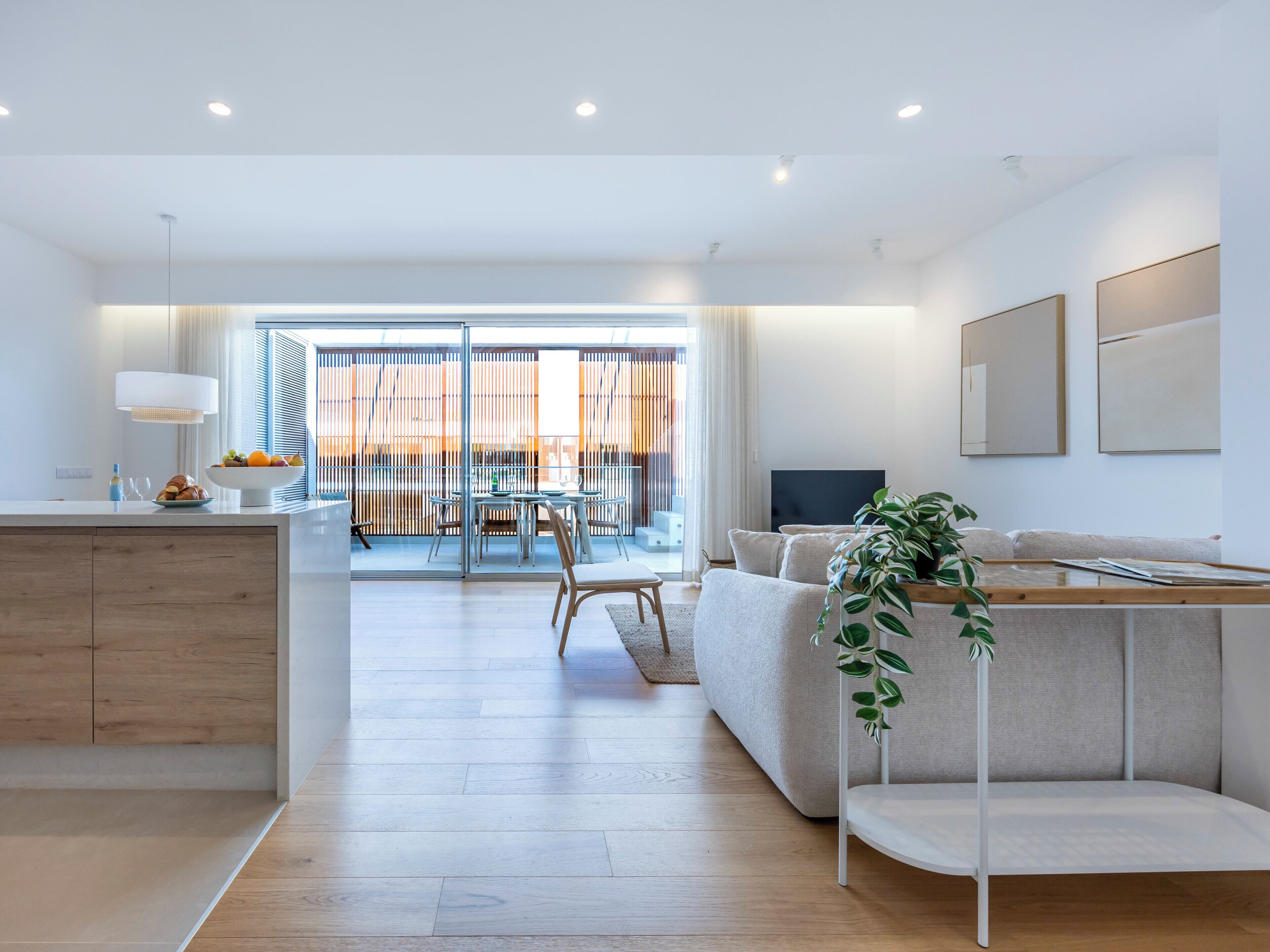 A modern living space with a kitchen, dining area, and seating area.