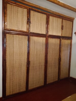 A room with a large wooden wardrobe with a woven back panel. - Kizakura Homes-Spacious 6-bedroom Villa in Marine Park. Malindi Kenya (Malindi)