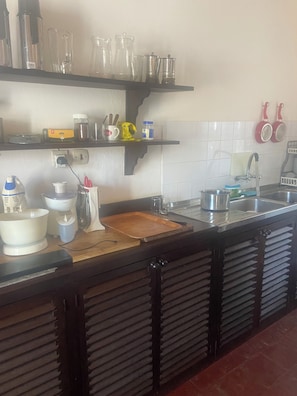 A kitchen with a wooden countertop, a sink, and various kitchen utensils and appliances. - Kizakura Homes-Spacious 6-bedroom Villa in Marine Park. Malindi Kenya (Malindi)