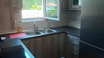 Cafetera o tetera, frigorífico, horno y placa de cocina