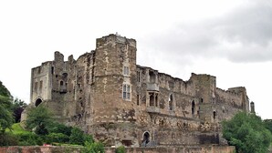 A historic castle with multiple towers and arched windows, situated by a river. - Riverside Escape - Newark on Trent (Newark)