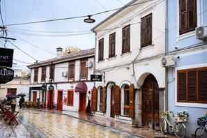A street with buildings, a bicycle, and a sign for 'CULTURA'. - Mon Ami Boutique Hotel  (Shkoder)