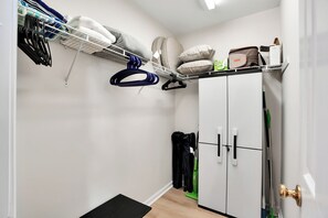 A walk-in closet with shelves, hanging space, and a wardrobe. - Walk to Oak Island Beach! Casablanca Estate (Oak Island)