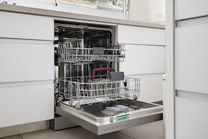 An open dishwasher with multiple racks and a control panel. - Spacious Quiet 2BR & Parking City Center by FeelHome (Tel Aviv - Jaffa)