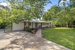 A single-story house with a front porch, a small front yard, and a pathway leading to the entrance. - Nature Coast Getaway w/Gulf Access (Inglis)