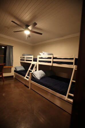 A room with bunk beds, a desk, and a ceiling fan. - Dutton Chapel Lodge (Golconda No. 2 Precinct)