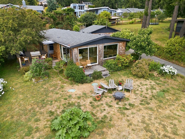 A house with a patio, outdoor seating, and a garden. - Walk to Private Beach: Bay-View Whidbey Island Gem (Oak Harbor)