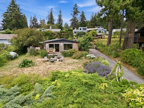 A residential property with a patio area, outdoor seating, and a variety of vegetation. - Walk to Private Beach: Bay-View Whidbey Island Gem (Oak Harbor)