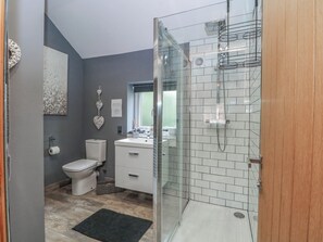 A modern bathroom with a glass shower enclosure, a toilet, a sink, and a mirror. - Barn 2 (Sandbach)