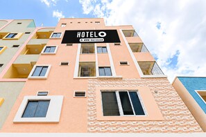 A multi-story hotel building with a prominent 'HOTEL' sign. - Classic SLN Terminus Gachibowli (Hyderabad)