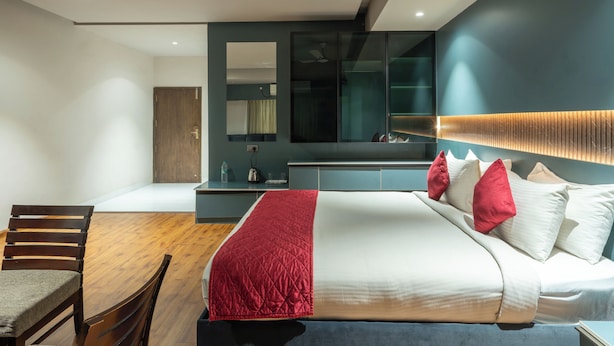 A modern bedroom with a bed, a desk, and a chair. - Midland Residency (Coimbatore)