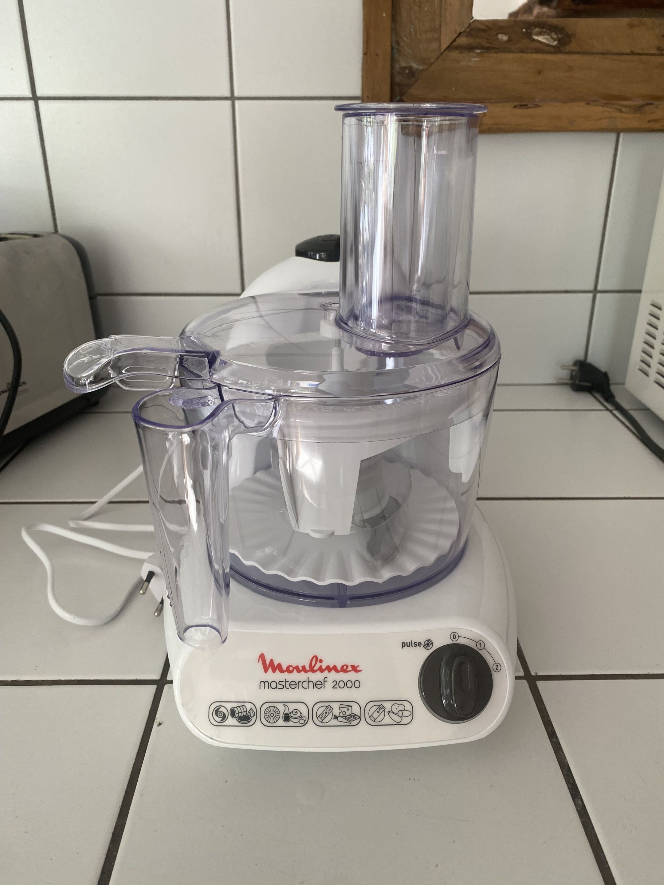 A Moulmex Masterchef 2000 food processor on a tiled kitchen counter.