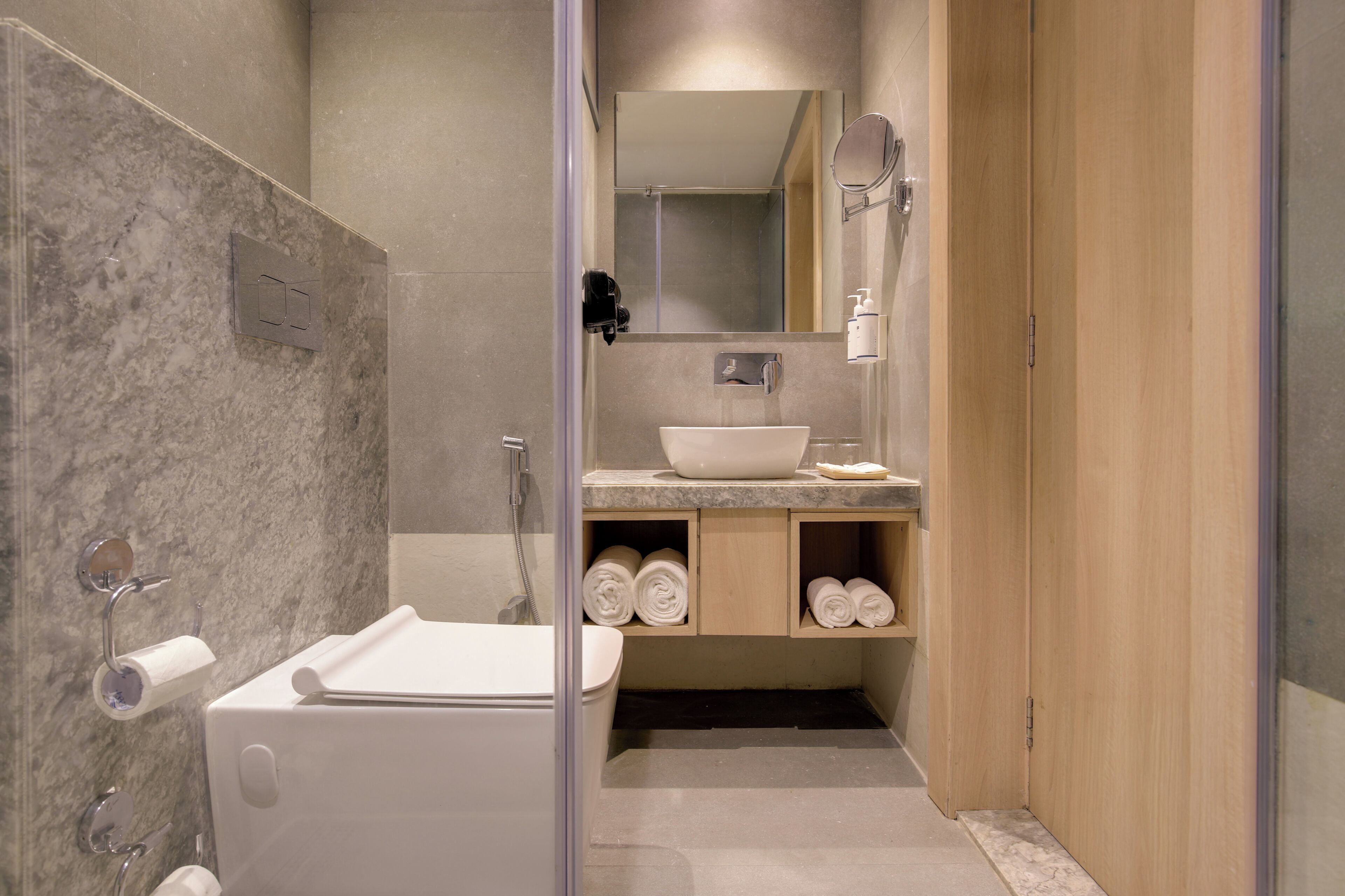 A modern bathroom with a bathtub, a sink, a mirror, and a shower.