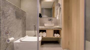 A modern bathroom with a bathtub, a sink, a mirror, and a shower.