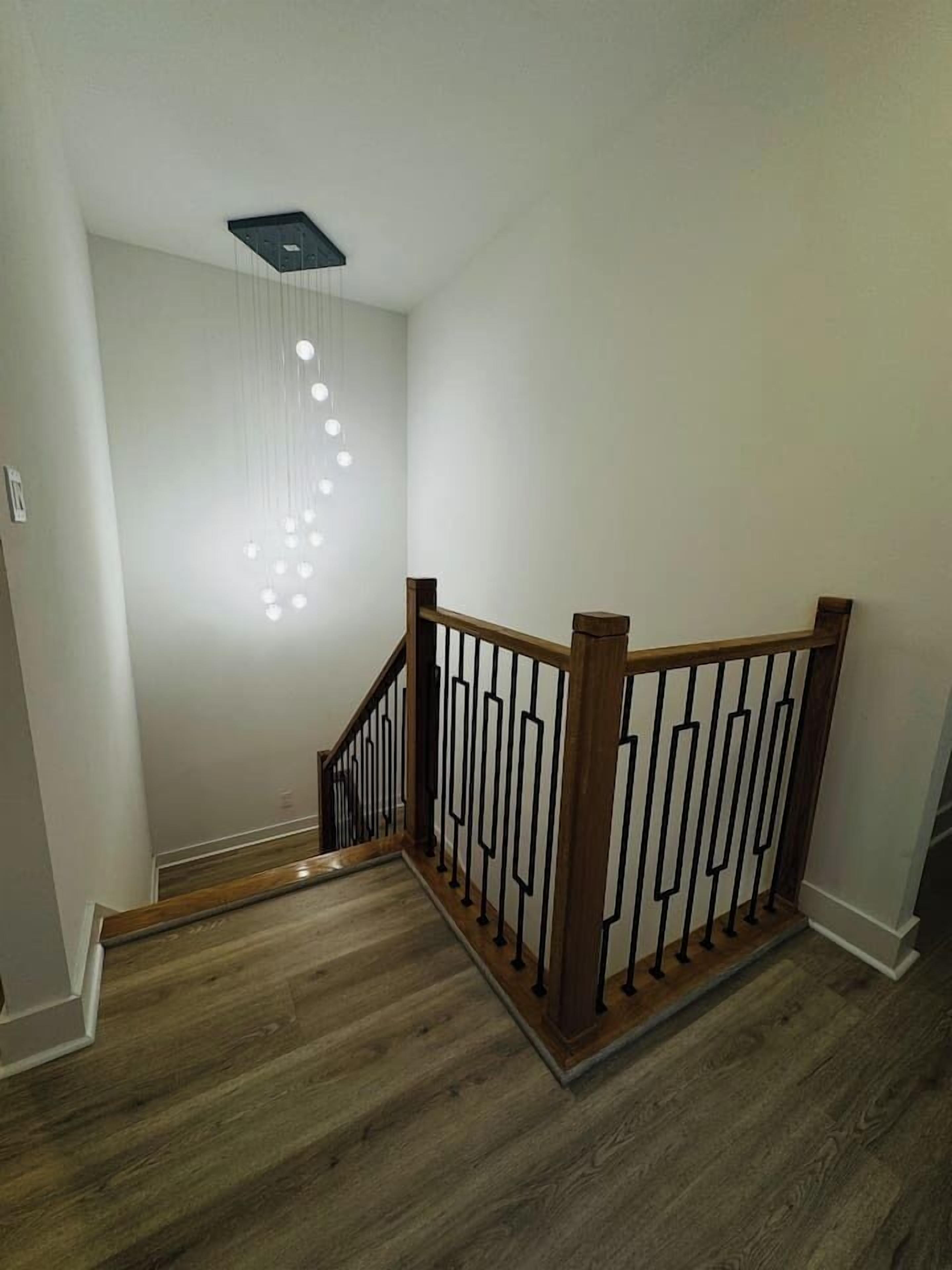 A staircase with wooden steps and a metal railing.