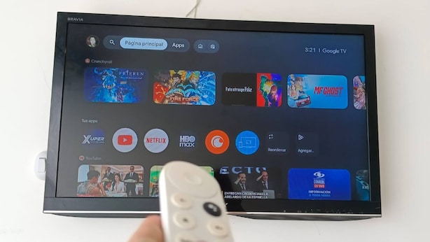 A television displaying a streaming service interface with various apps and a remote control in front. - VIP Nomad Nest in New PH With Air C, Kitchen, Steps to Metroplus (Medellín)