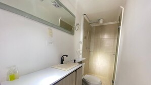 A bathroom with a white sink, mirror, and toilet. - VIP Nomad Nest in New PH With Air C, Kitchen, Steps to Metroplus (Medellín)