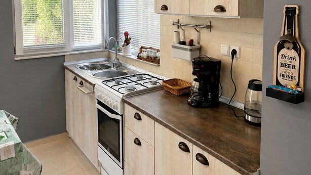 A compact kitchen with a gas stove, oven, and a coffee maker on the counter. - Lovely private house on the Shekvetili coast (Shekvetili)
