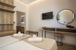 A hotel room with two beds, a TV, a mirror, a desk, and a small stool. - 2BR Apartment with 2 Bathrooms in Rhodes Center (Rhodes)