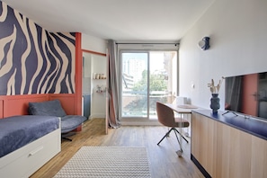 Ein modernes Schlafzimmer mit einem Bett, einem Schreibtisch und einem großen Fenster.