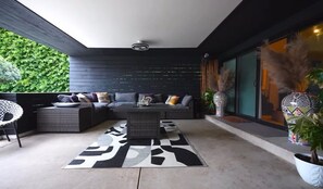 A modern outdoor seating area with a sectional sofa, a coffee table, and decorative pillows. - Spacious private Oasis (Los Angeles)