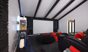 A home theater room with a large screen, comfortable seating, and a popcorn machine. - Spacious private Oasis (Los Angeles)
