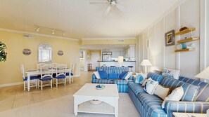 A living room with a sofa, chairs, a coffee table, and a dining area with a table and chairs. - Lorelei II 405 - Your perfect Ocean City getaway! (Ocean City)