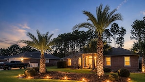 A residential property with a well-maintained lawn, a house with a brick facade, and a garage. - Netsled in  Navarre (Navarre)