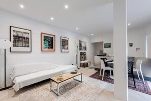 A modern bedroom with a single bed, a small table, and a desk area. - 61-square-meter apartment with an 85-square-meter terrace and direct access to the pool. Hossegor Lake (Soorts-Hossegor)