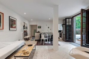 A modern interior with a sofa, dining table, and kitchen area. - 61-square-meter apartment with an 85-square-meter terrace and direct access to the pool. Hossegor Lake (Soorts-Hossegor)