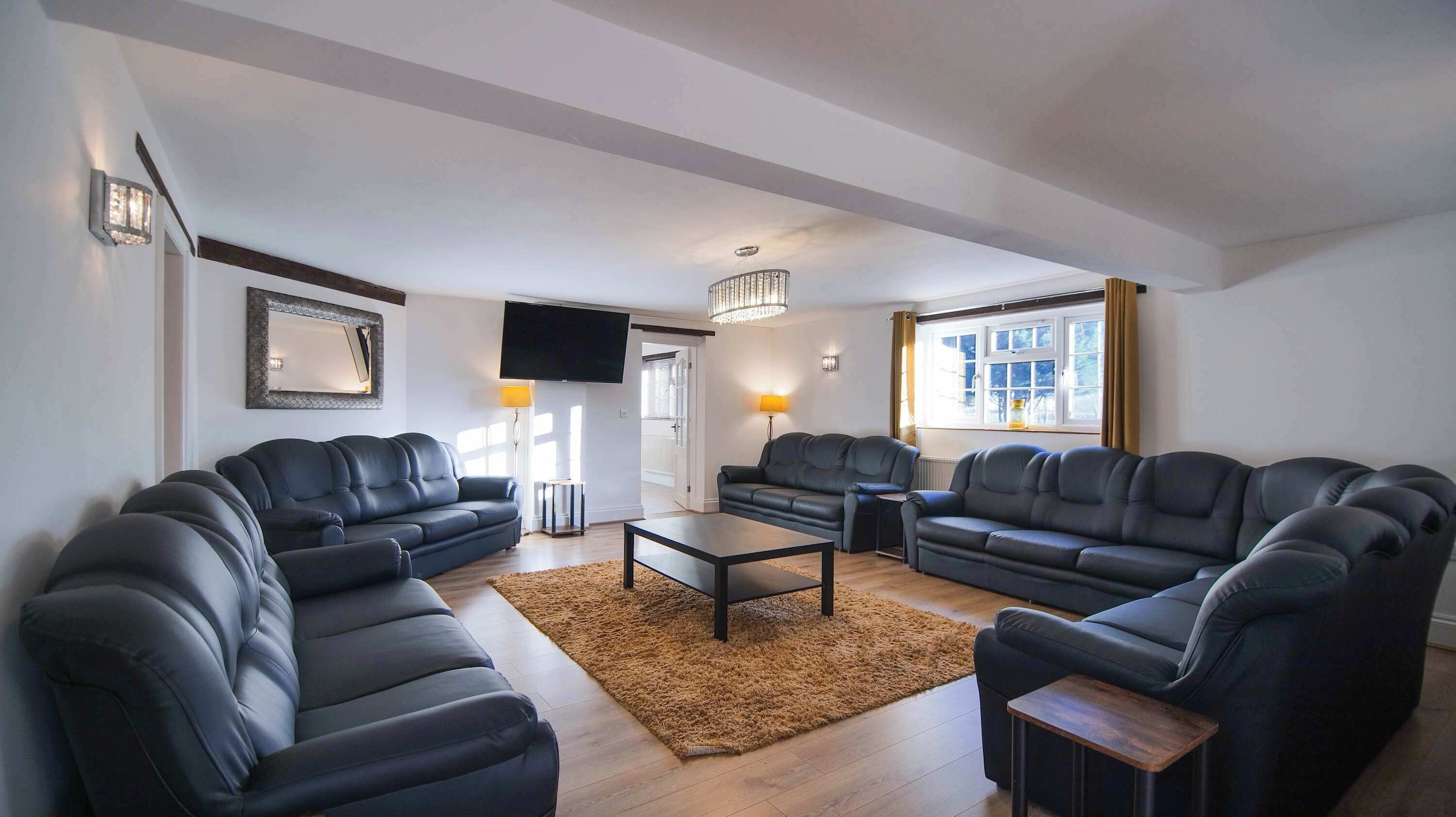 A modern living room with two sofas, a coffee table, and a TV.